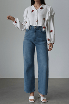 Sweet Countryside 100% cotton ruffled white blouse with strawberry prints paired with blue jeans.
