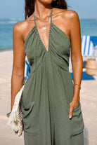 Sunshine On Sand olive green halter-neck jumpsuit with ruched neckline and wide legs perfect for beach and casual wear