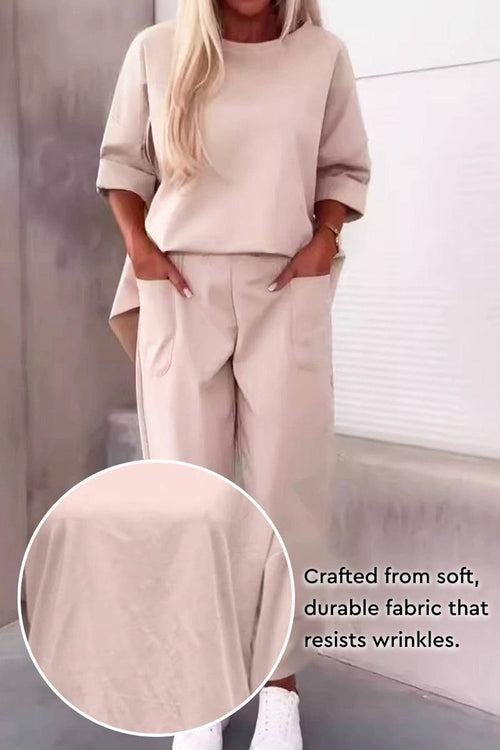 Beige two-piece set with crew neck sweatshirt and jogger pants, wrinkle-resistant polyester fabric, casual and comfortable style.