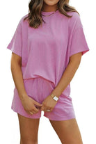 Women wearing relaxed fit pink textured two-piece set for slow mornings with short sleeves and shorts