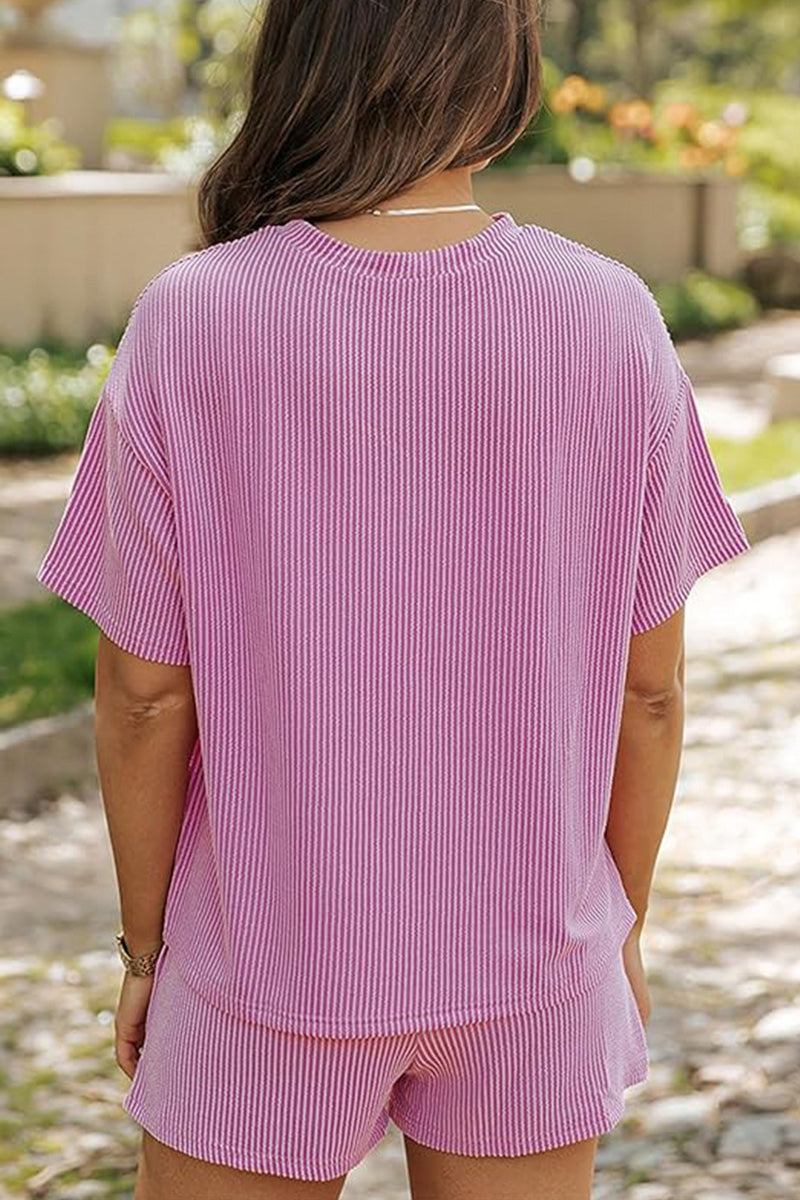 Woman wearing a relaxed pink textured short sleeve top and matching shorts set, perfect for slow mornings and casual comfort