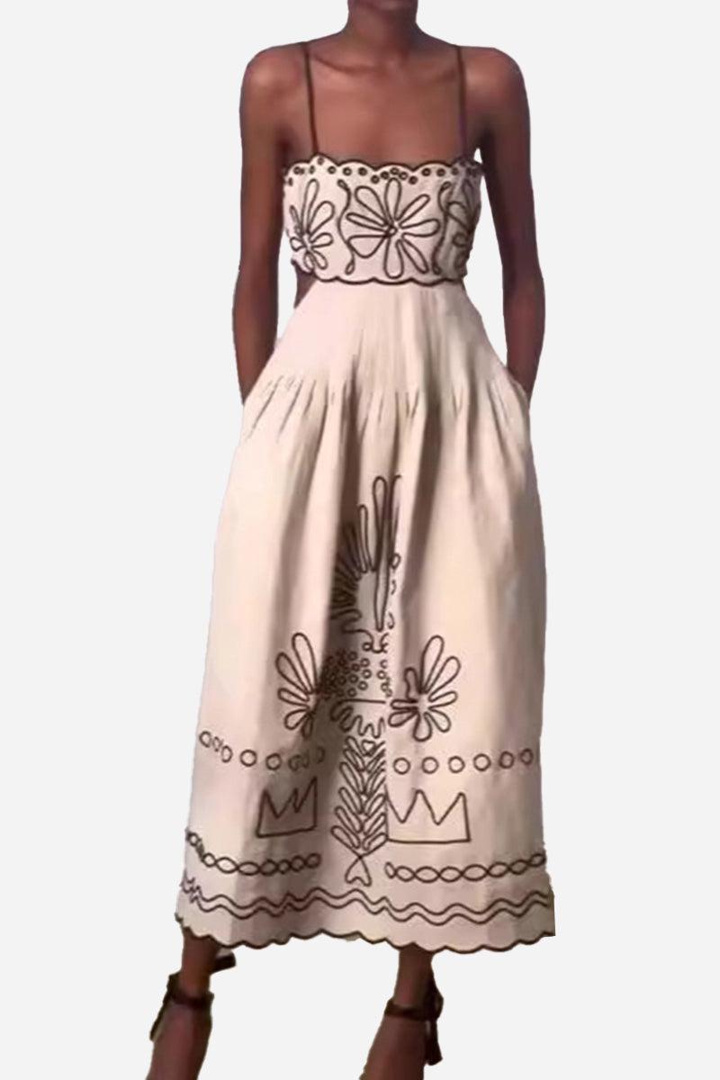 Artisan embroidered scallop edge bohemian maxi dress with floral and geometric patterns and spaghetti straps.
