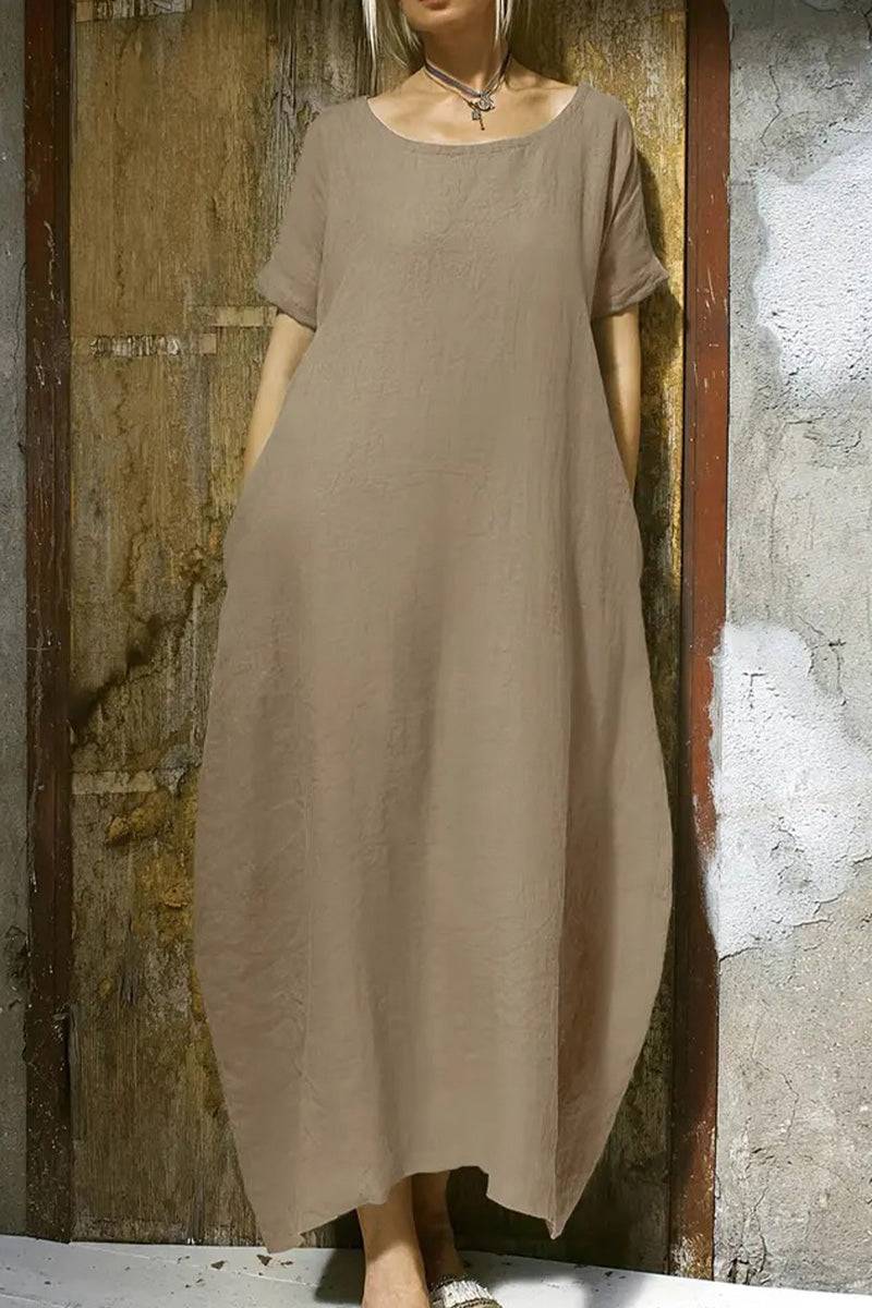 Breeze Cocoon Dress in beige linen-like fabric with rolled sleeves and relaxed airy silhouette.