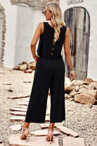 woman wearing black Villa Lounge Linen Set two-piece outfit with sleeveless top and wide-leg pants outdoors
