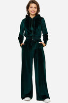Dark green velour tracksuit with cropped hoodie and high-waist pants in plush polyester fabric