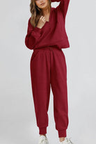 Unisex half-zip pullover and sweatpants set in burgundy, soft polyester blend, casual and comfortable lounge wear.