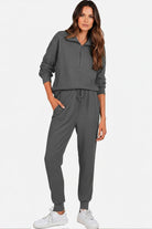 Unisex half-zip pullover and sweatpants set in dark gray, lightweight polyester blend for casual comfort and style.