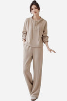 Woman wearing Quiet Comfort Everyday beige two-piece set with henley-style hoodie and wide-leg pants