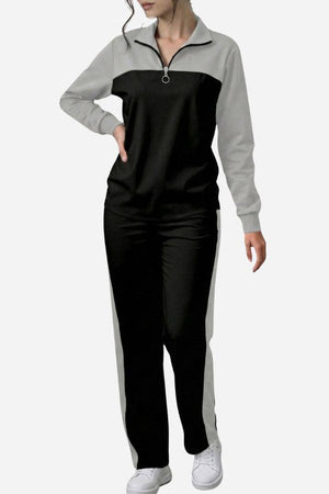 Woman wearing Colorblock Comfort Leisure Set with half-zip, stand collar, black and grey color-block design, and wide-leg pants.