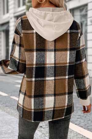 Back view of Countryside Layered Hoodie with brown plaid pattern and beige hood on woman outdoors