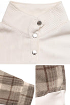 Close-up of waffle knit sweatshirt with button detail and plaid flannel sleeves in neutral tones