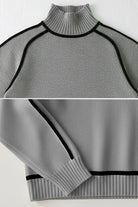 Gray Zero Itch Turtleneck Sweater with black contrast trim and soft knit fabric