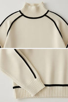 Cream Zero Itch Turtleneck Sweater with black slimming contrast trim, soft knit, and relaxed fit