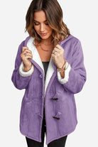 Woman wearing purple warm toggle button hooded coat with sherpa lining and faux suede exterior