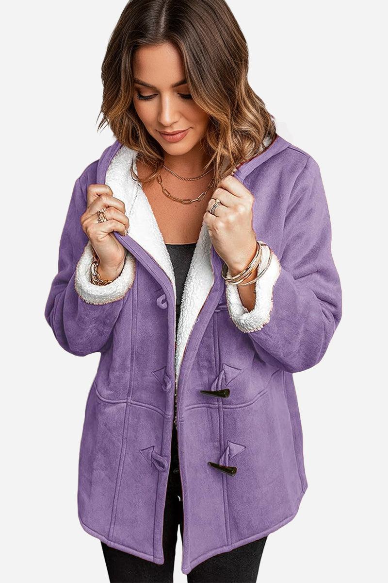 Woman wearing purple warm toggle button hooded coat with sherpa lining and faux suede exterior