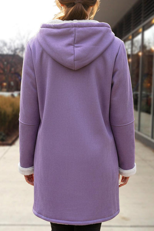 Back view of a woman wearing a lavender Warm Toggle Button Hooded Coat with sherpa lining and hood outdoors