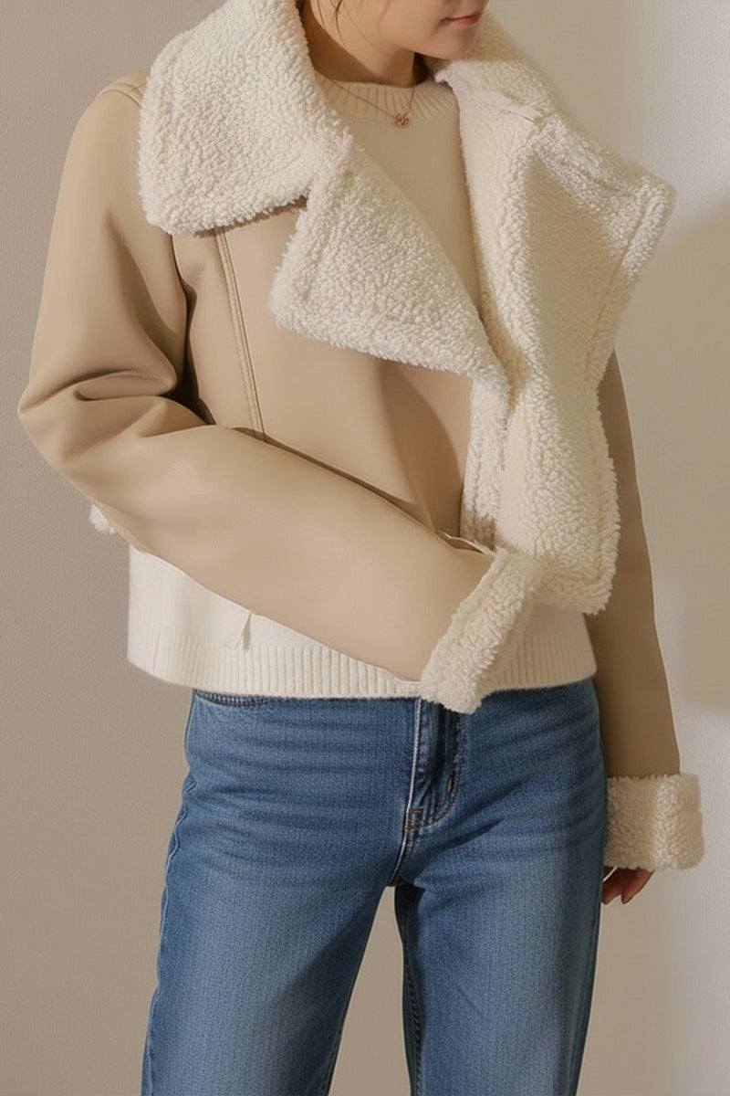 Woman wearing cropped faux leather sherpa jacket with cream shearling collar and cuffs
