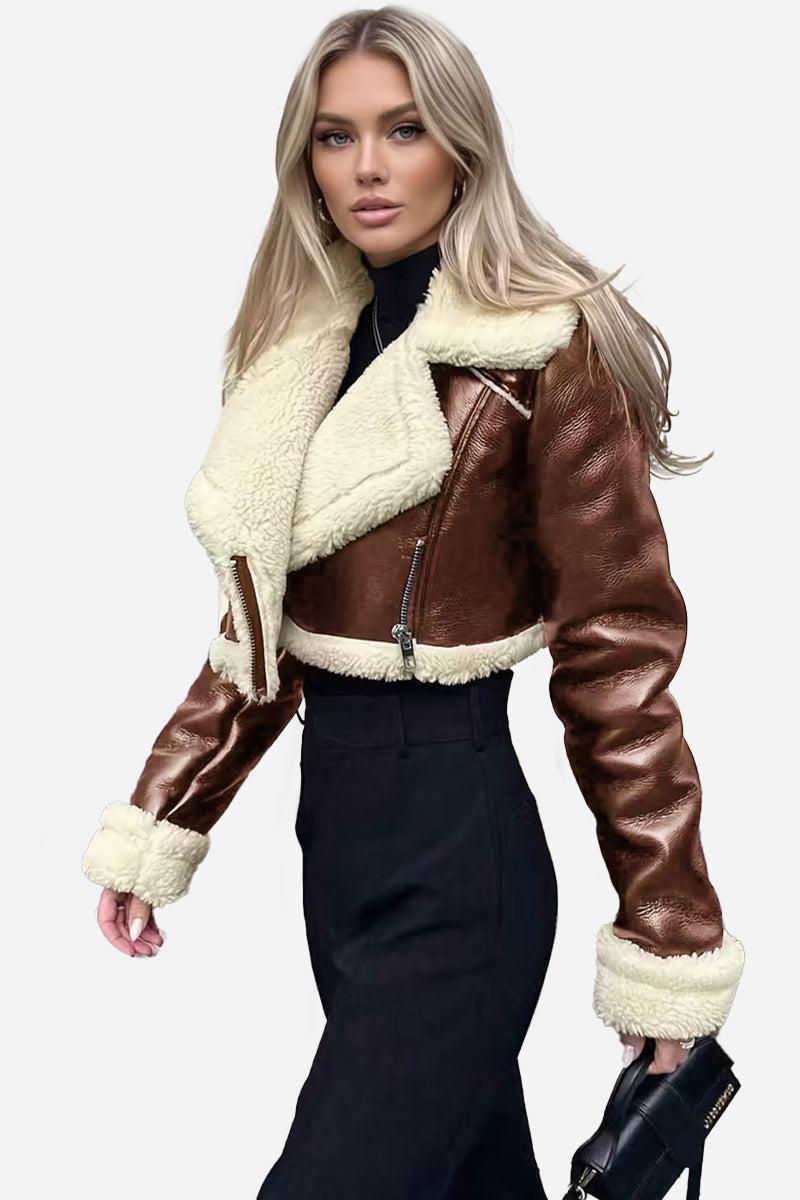 Cropped faux leather sherpa jacket with cream trim and zip front closure, styled for a fitted, warm look