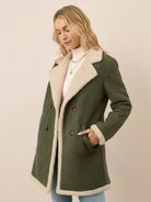 Women's faux suede sherpa coat with contrast trim, mid-thigh length, and side pockets for transitional weather.
