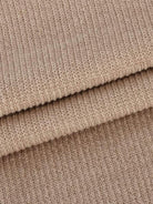 Close-up of soft beige waffle-knit fabric texture for waffle-knit two-piece set