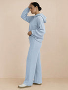 woman wearing light blue waffle-knit two-piece hoodie and pants lounge set