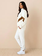 Woman wearing a colorblock comfort tracksuit with contrast curved panels and stand collar jacket