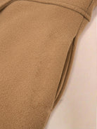 Women's fit and flare trench coat with tailored waist and pleated hem in non-wool fabric