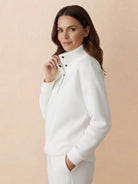 woman wearing white warm and easy two-piece set with button-collar pullover and matching pants