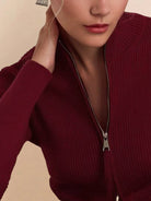 Women's zip-up ribbed knit cardigan with high neckline and fitted cuffs