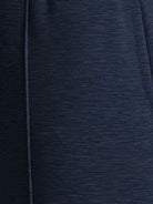 Soft knit wide-leg pants with breathable fabric, elastic drawstring waist, and side pockets for a relaxed everyday fit