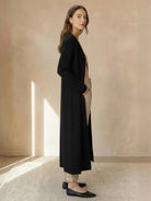 Long cardigan made of 100% Australian Merino wool with open front and patch pockets.