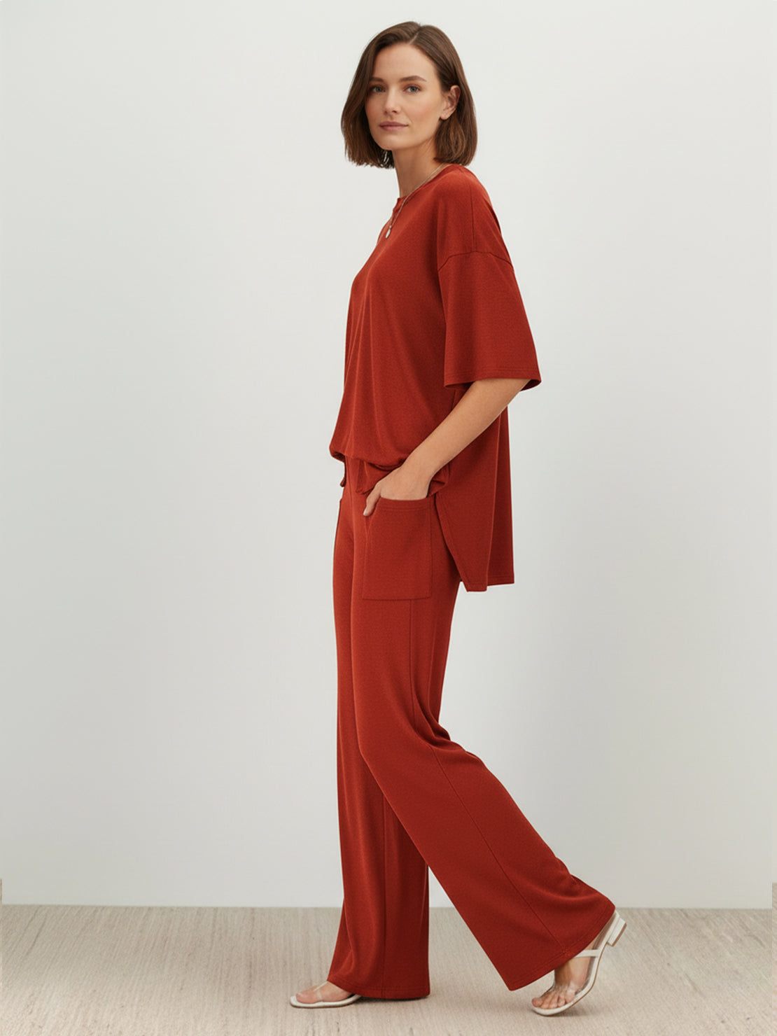 Woman wearing oversized long-line loungewear set with short-sleeve pullover and wide-leg pants