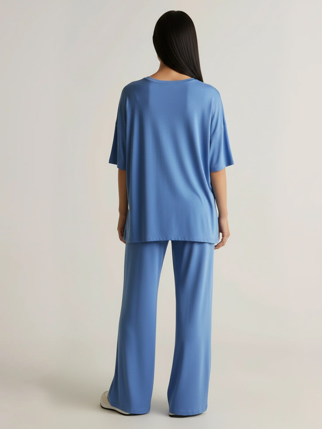 Woman wearing oversized long-line loungewear set with pullover and wide-leg pants