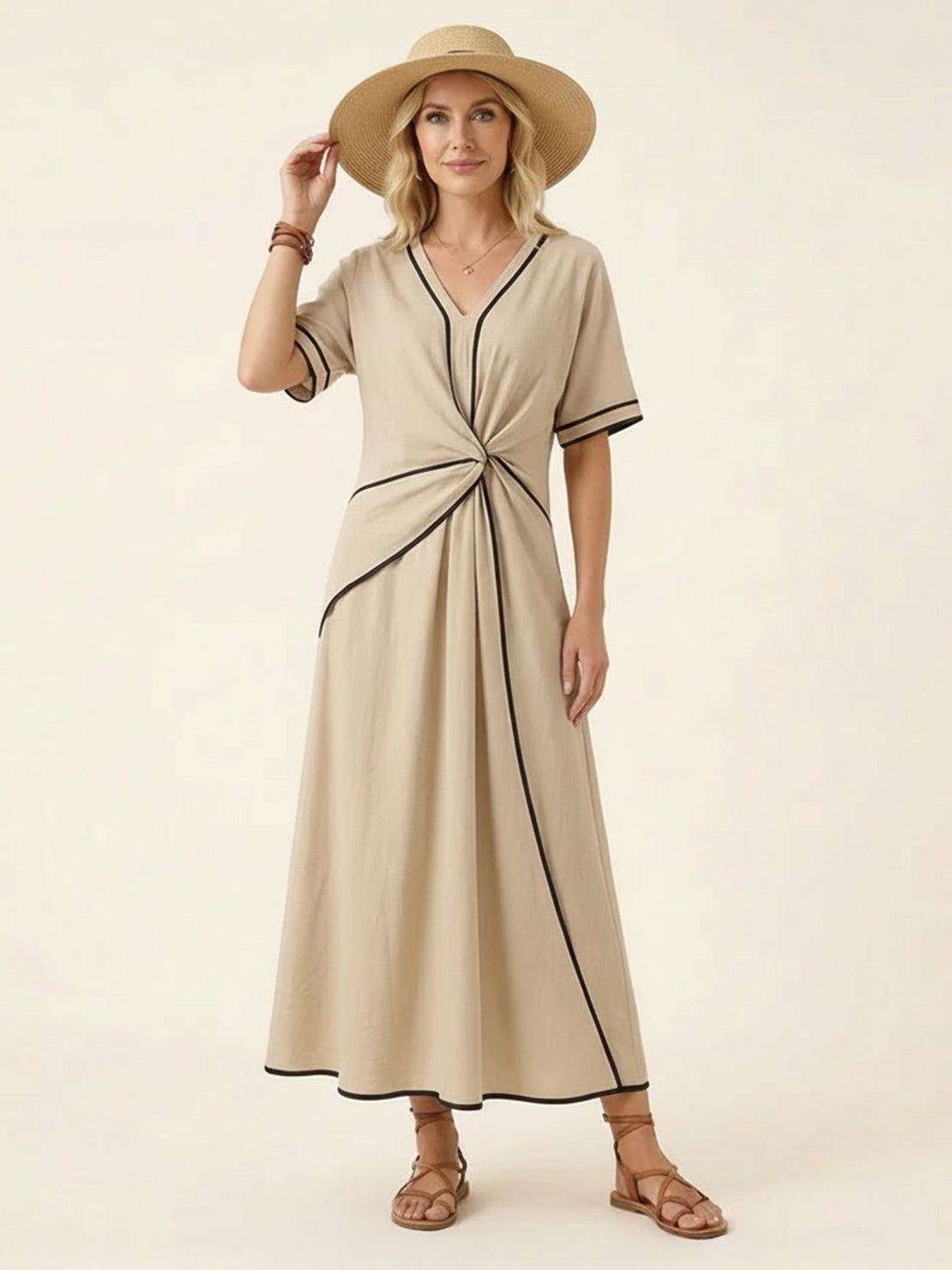 Woman wearing a knot-waist maxi dress with V-neckline and flowing skirt