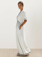 Black knot-waist maxi dress with V-neckline and flowing skirt