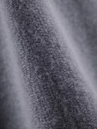 Woman wearing oversized polo knit loungewear set with soft collar and straight-leg pants