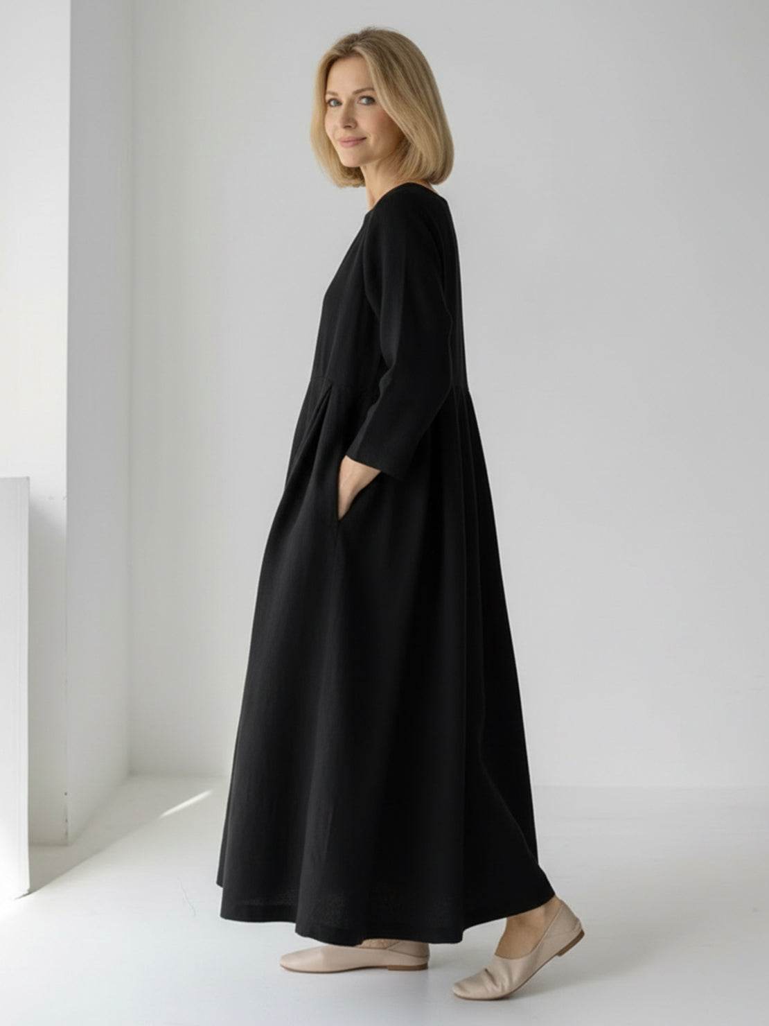 Woman wearing 100% cotton-linen empire waist maxi dress with 3/4 sleeves and pockets