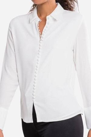 White Bayam Blouse with button detail and classic collar, long sleeves, made of 100% polyester.