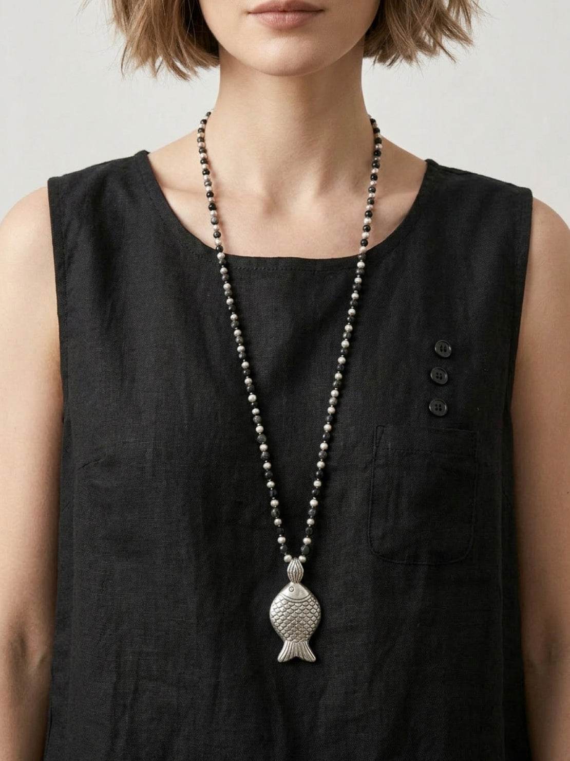 Lightweight 100% cotton linen sleeveless top with relaxed fit, curved hem, chest pocket, and side slits for comfort