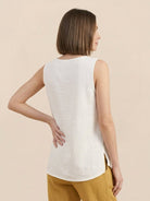 100% cotton linen sleeveless top with relaxed fit, curved hem, and chest pocket detail