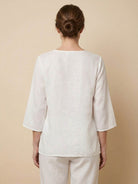 100% cotton linen hand-embroidered shirt with 3/4 flared sleeves and asymmetric hem