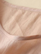 100% cotton linen hand-embroidered shirt with 3/4 flare sleeves and asymmetric hem featuring dense botanical embroidery