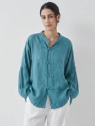 Oversized linen-cotton blouse with batwing sleeves and frog button closures