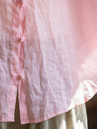 Oversized 100% linen blouse with frog-button closure and curved hem in lightweight fabric