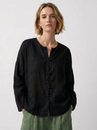 Oversized 100% linen blouse with frog-button closure, long sleeves, and curved hem in lightweight fabric