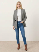 Black and white houndstooth commuter blazer with structured shoulders and relaxed fit