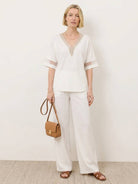 Mature woman wearing a lightweight linen top with short sleeves and three-button front detail
