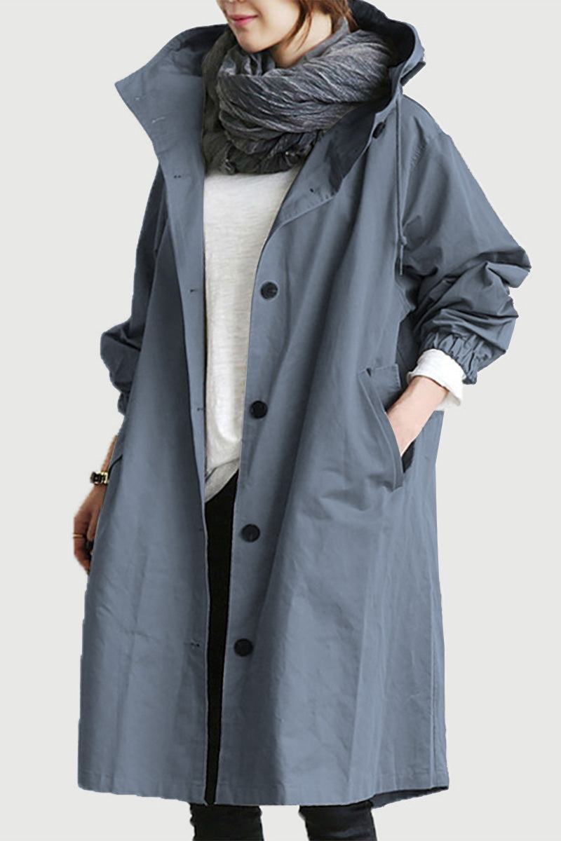 Woman wearing oversized water-resistant hooded windbreaker rain jacket in gray