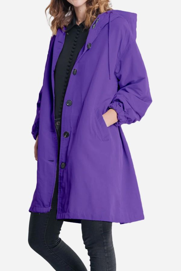 Water-resistant oversized purple hooded windbreaker jacket with button front and pockets