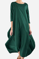 Bohemian maxi dress in dark green oversized linen blend with long sleeves and loose fit